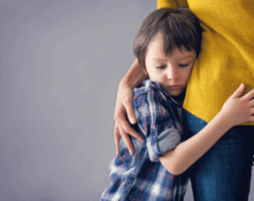 Image of a child hugging his parent.