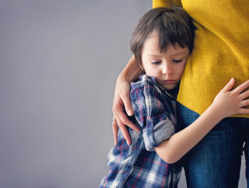 Image of a child hugging his parent.