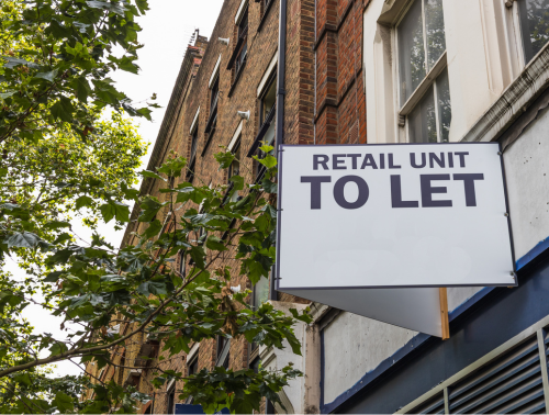 Photo of a sign on the side of a building with the words 'Retail Unit to Let'.