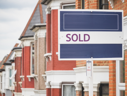 Sold sign displayed outside a terraced house in London.